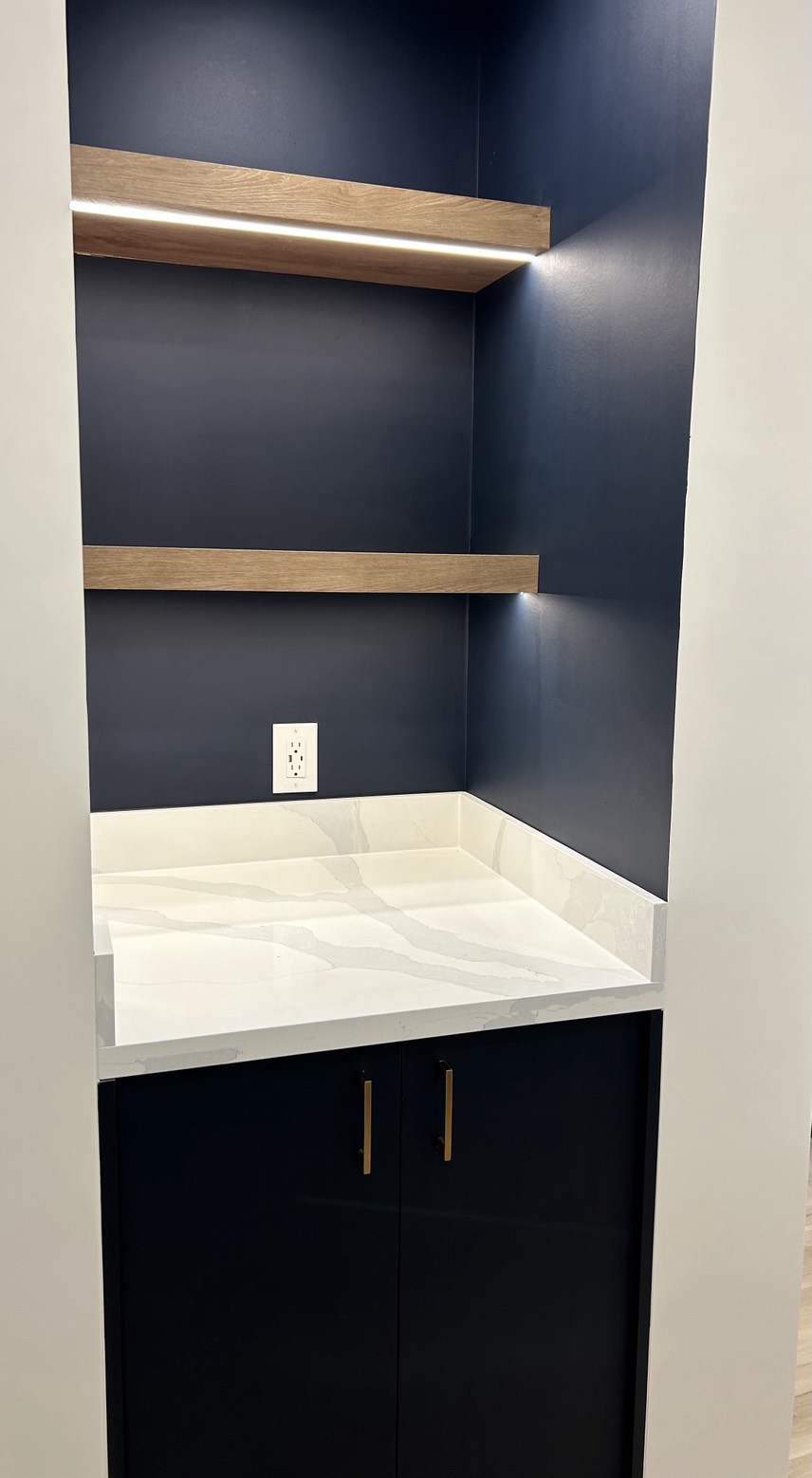 Built-in living room millwork with floating shelves and integrated lighting in Erin Mills, Mississauga